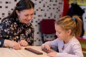 Young Female Teaching a Young Girl